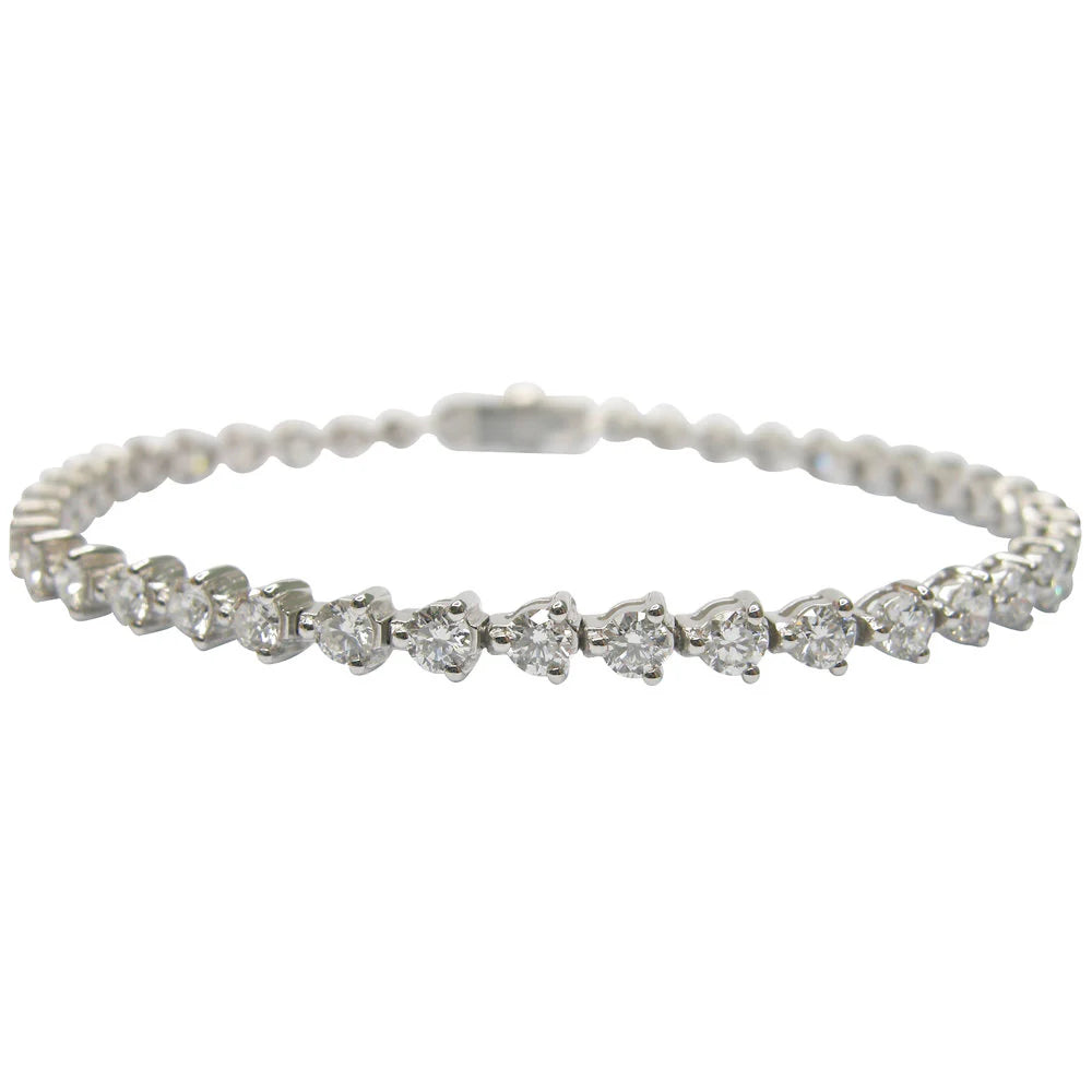 Silver bracelet with heart-shaped diamond charms on a white background