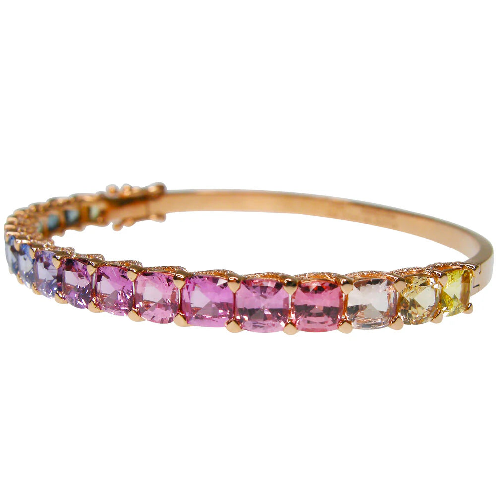 Gold bracelet with multicolored gemstones on a white background