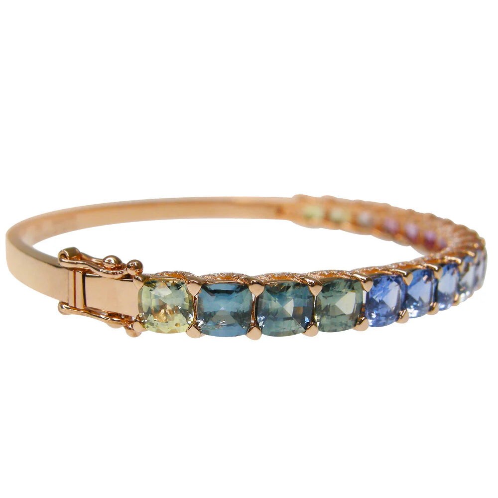 Rose gold bracelet with multicolored gemstones on a white background