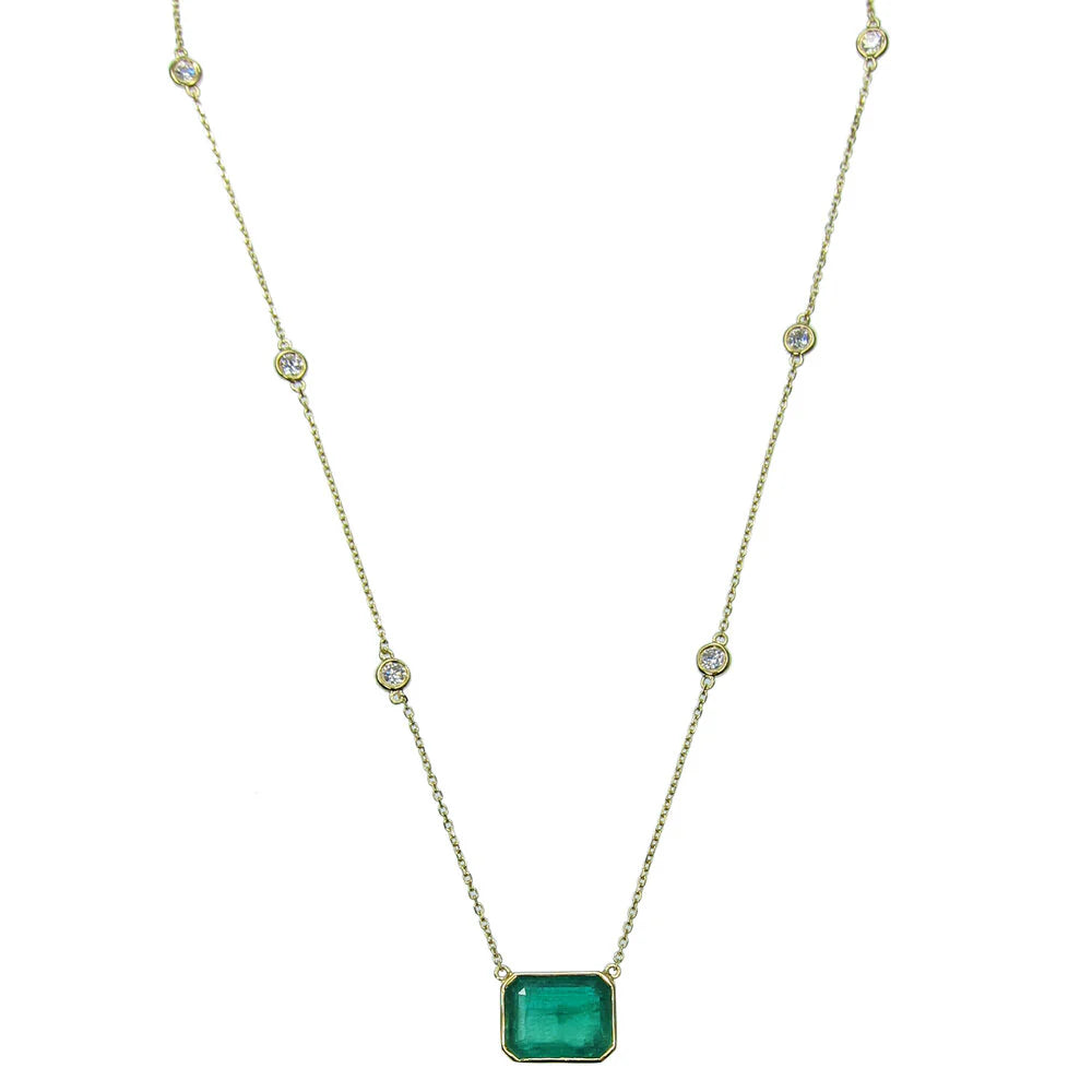 Necklace with a green gemstone pendant on a white background