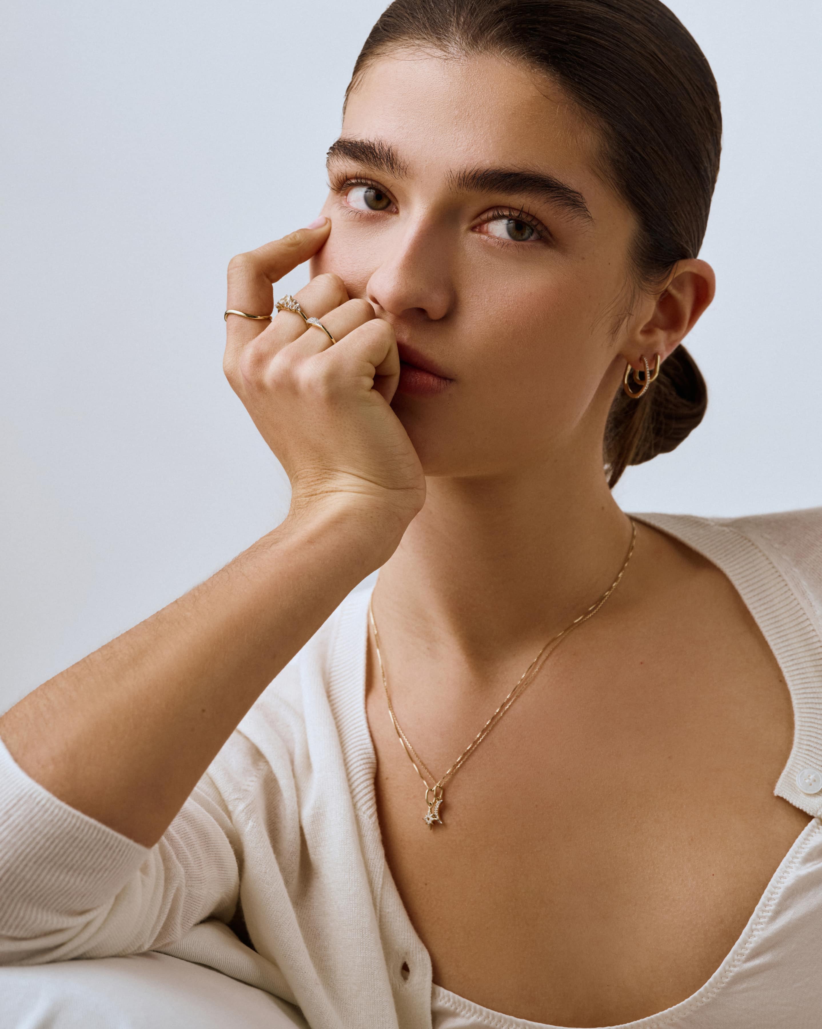 Woman wearing a necklace with a minimal background