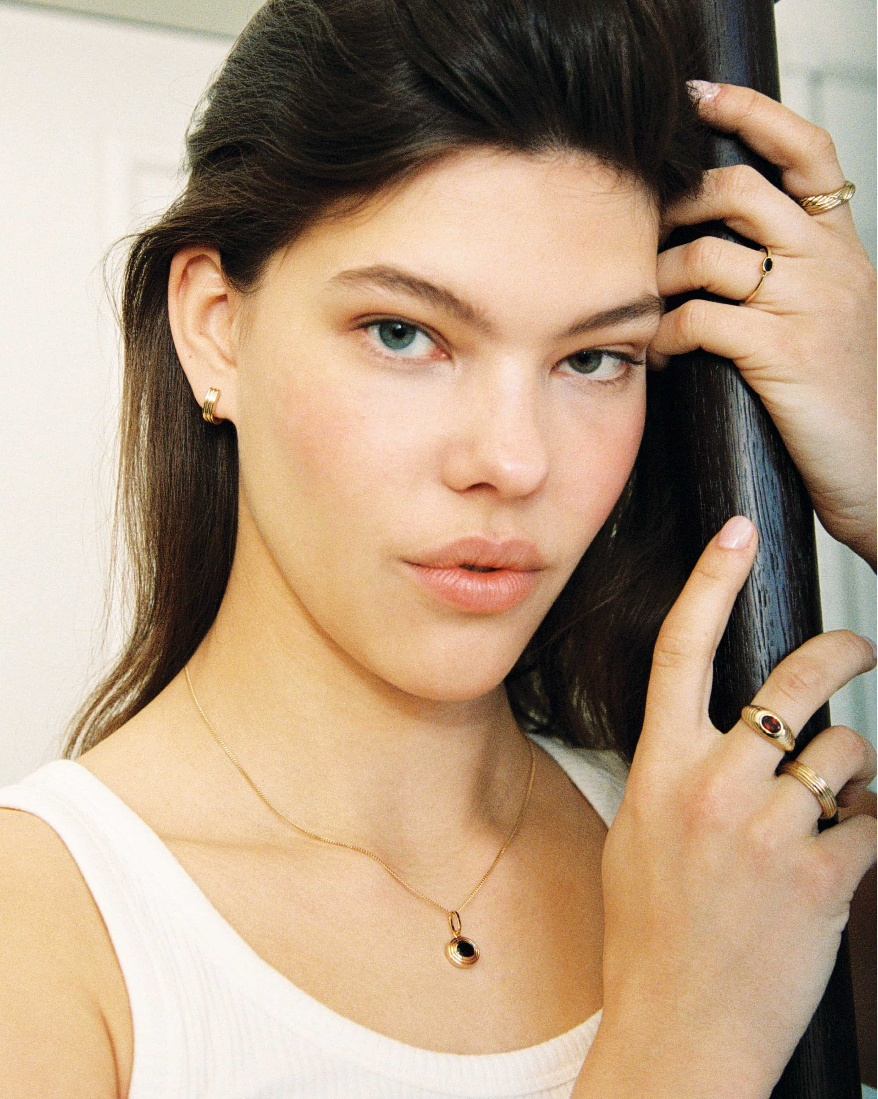 Beautiful model wearing the delicate Breno Natural Garnet Ring and matching jewelry by Handiora - 925 Sterling Silver and Gold Options