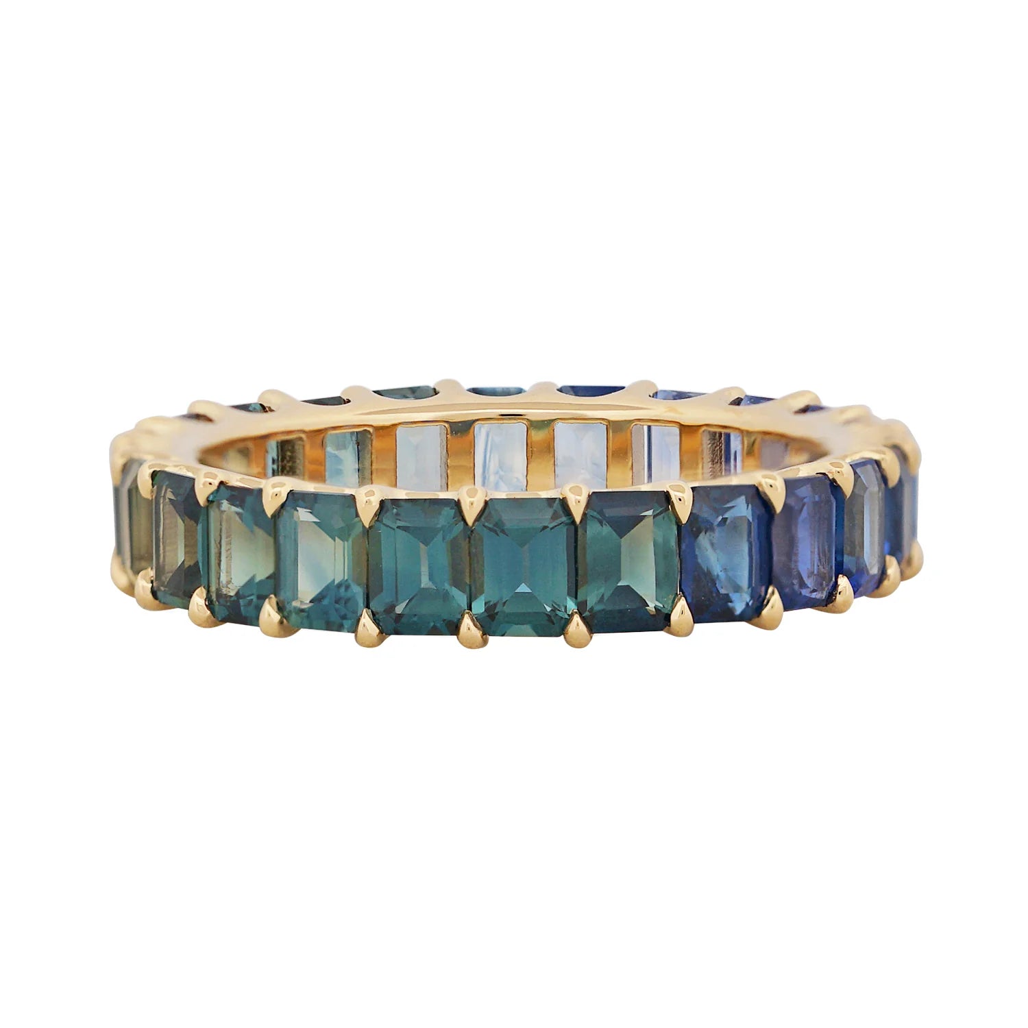 Gold ring with green and blue gemstones on a white background