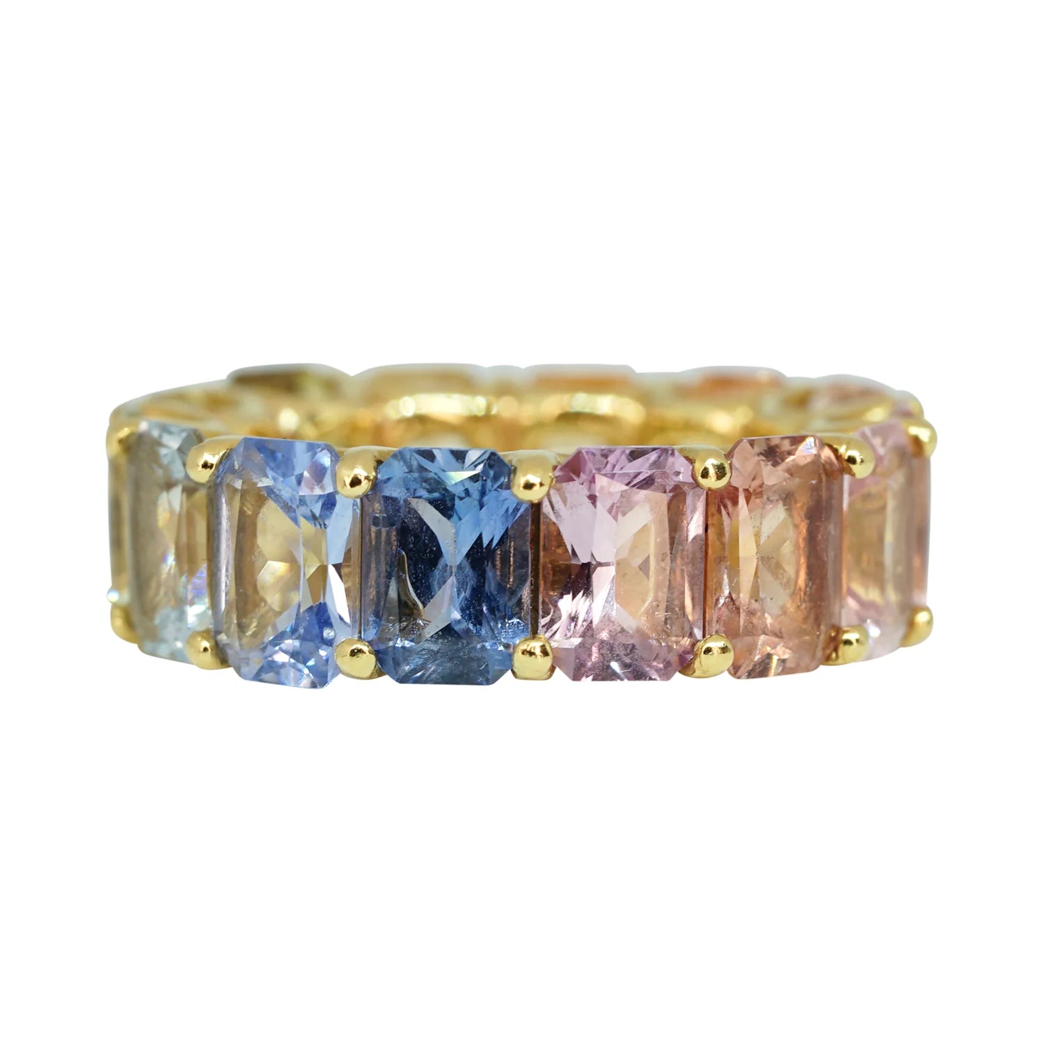 Gold ring with multicolored gemstones on a white background