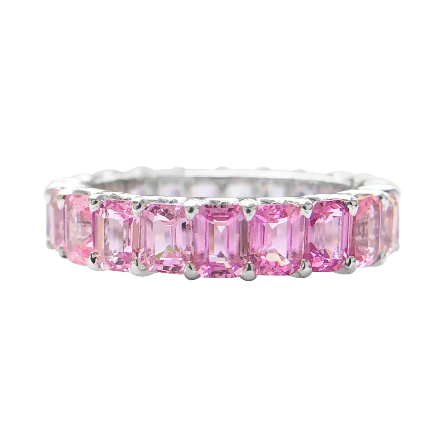 Pink gemstone ring with silver band on a white background