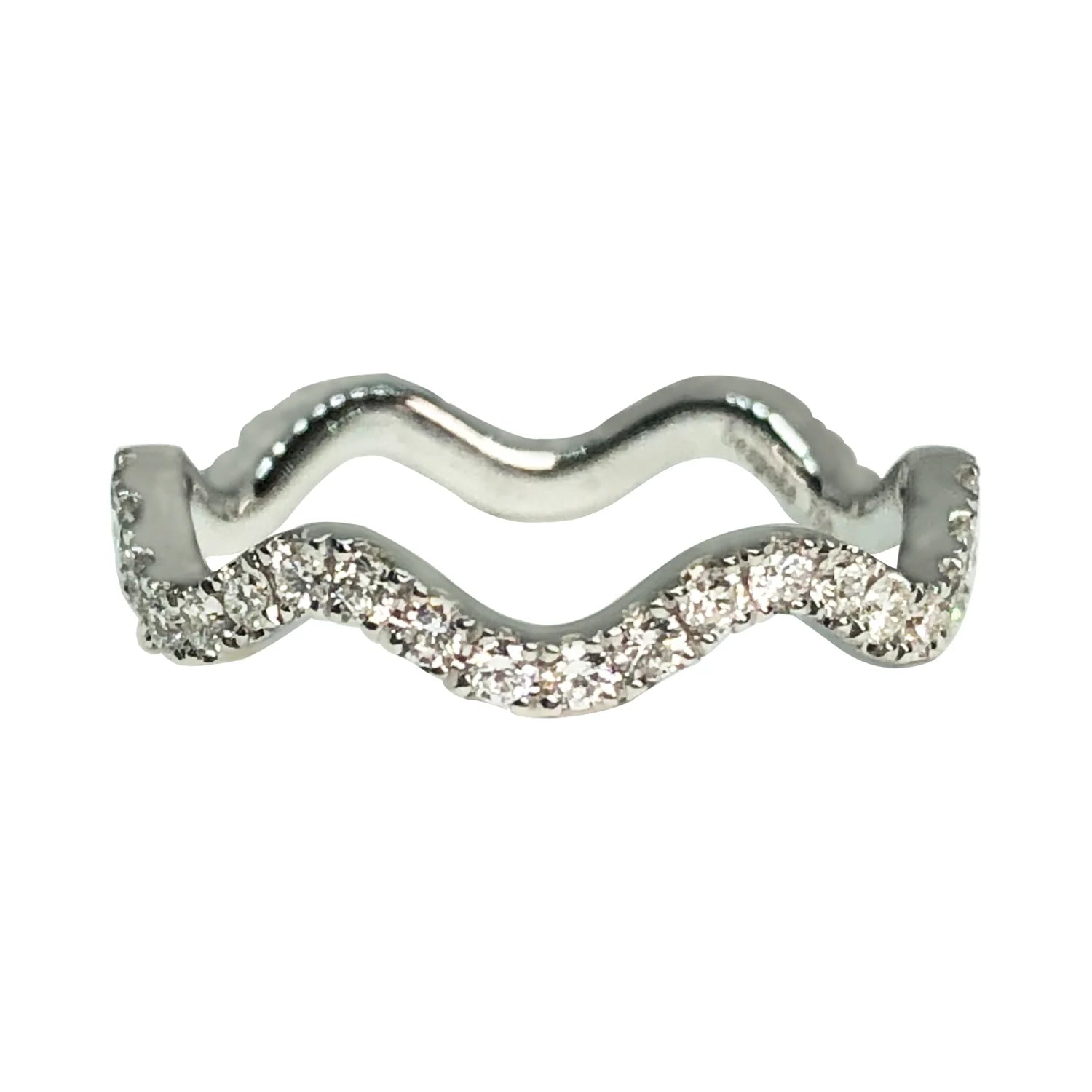 Silver ring with wavy design and embedded stones on a white background