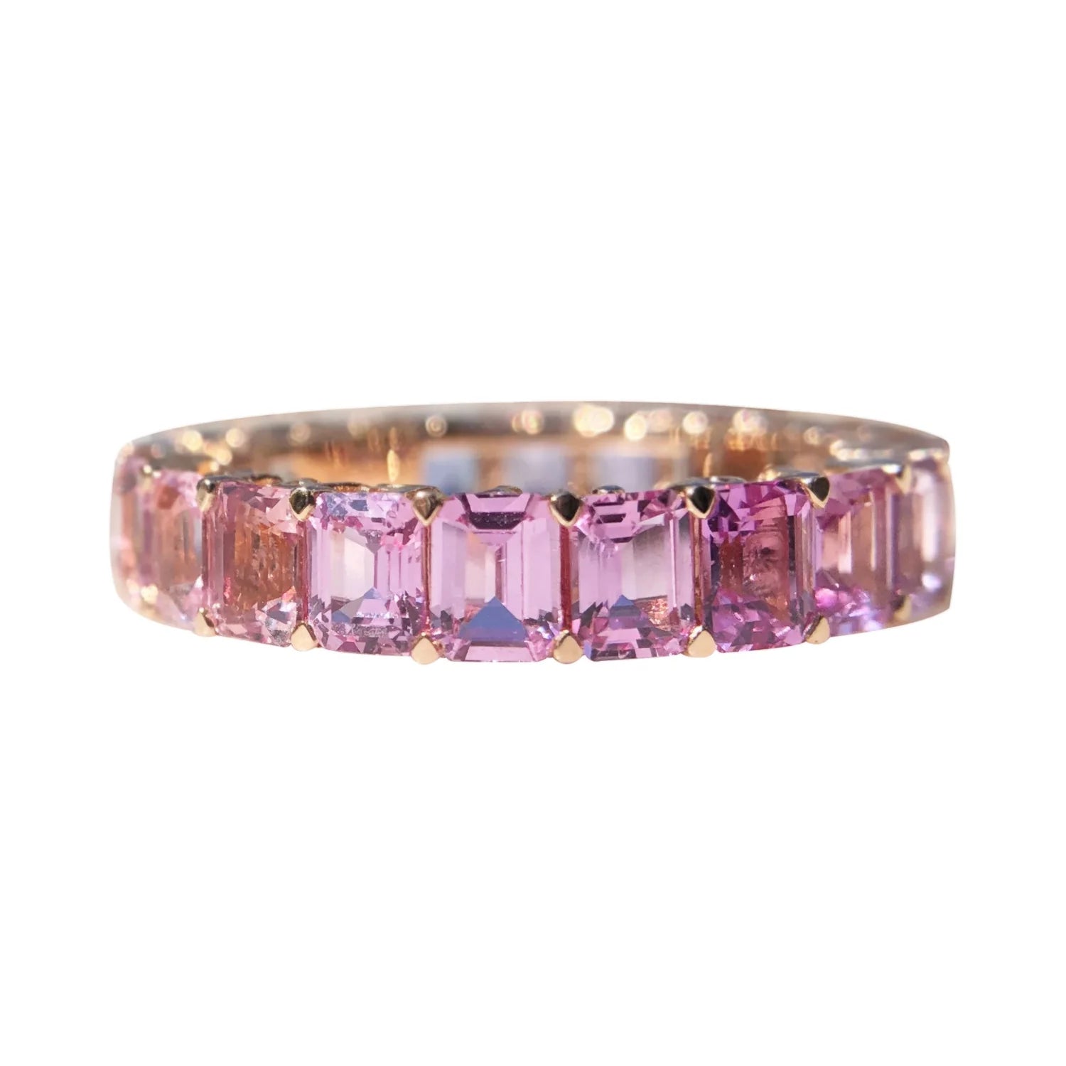 Ring with pink gemstones on a white background