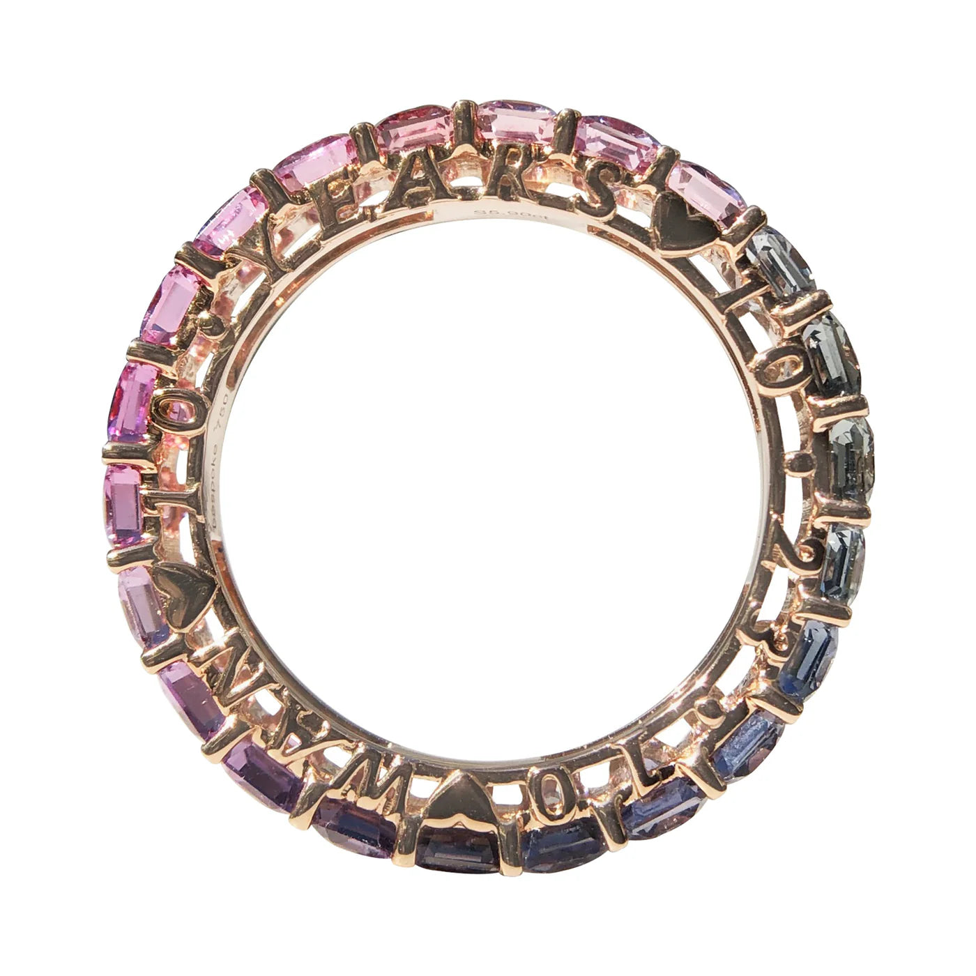 Circular ring with multicolored gemstones and rose gold border on a white background
