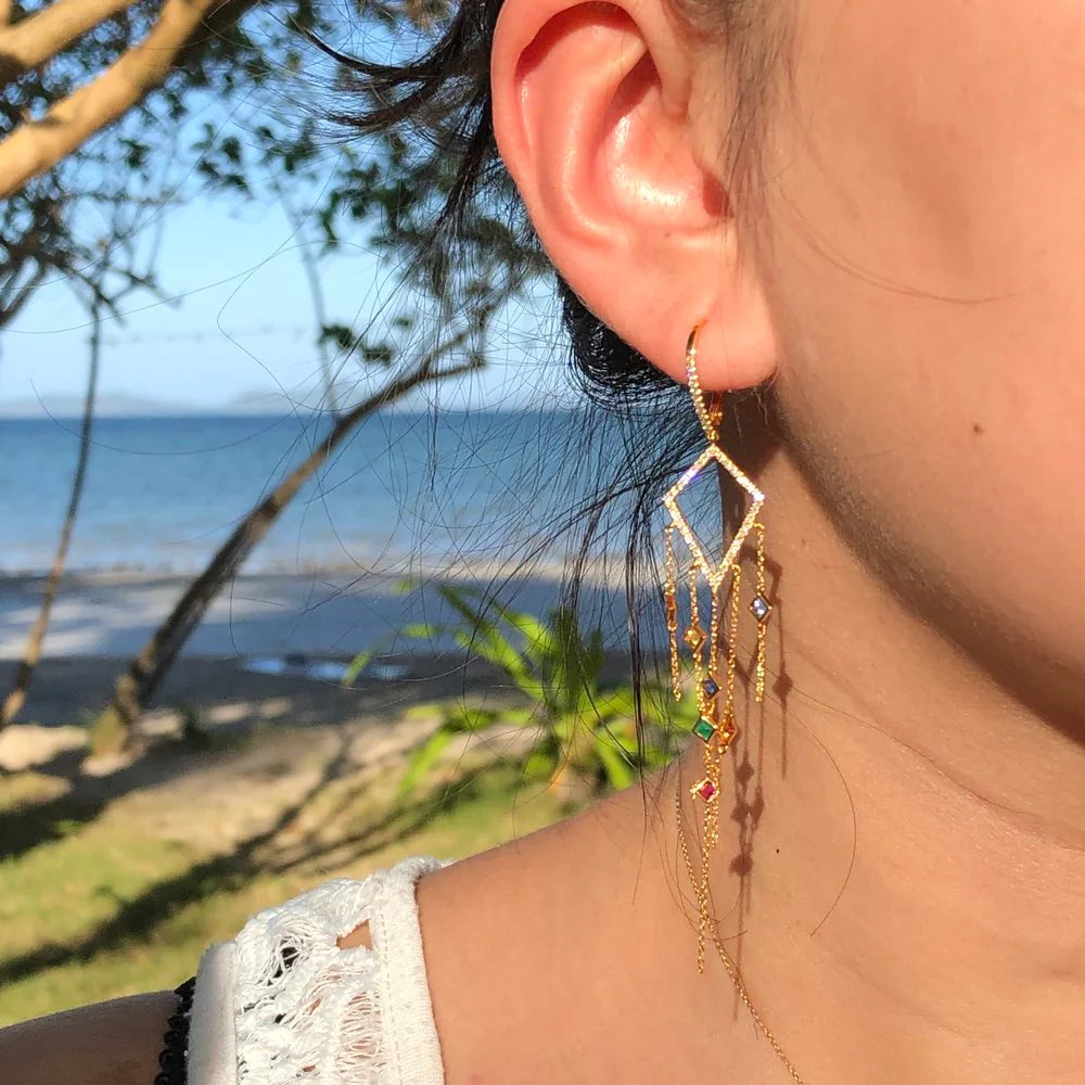 Close-up of an earring with a beach in the background