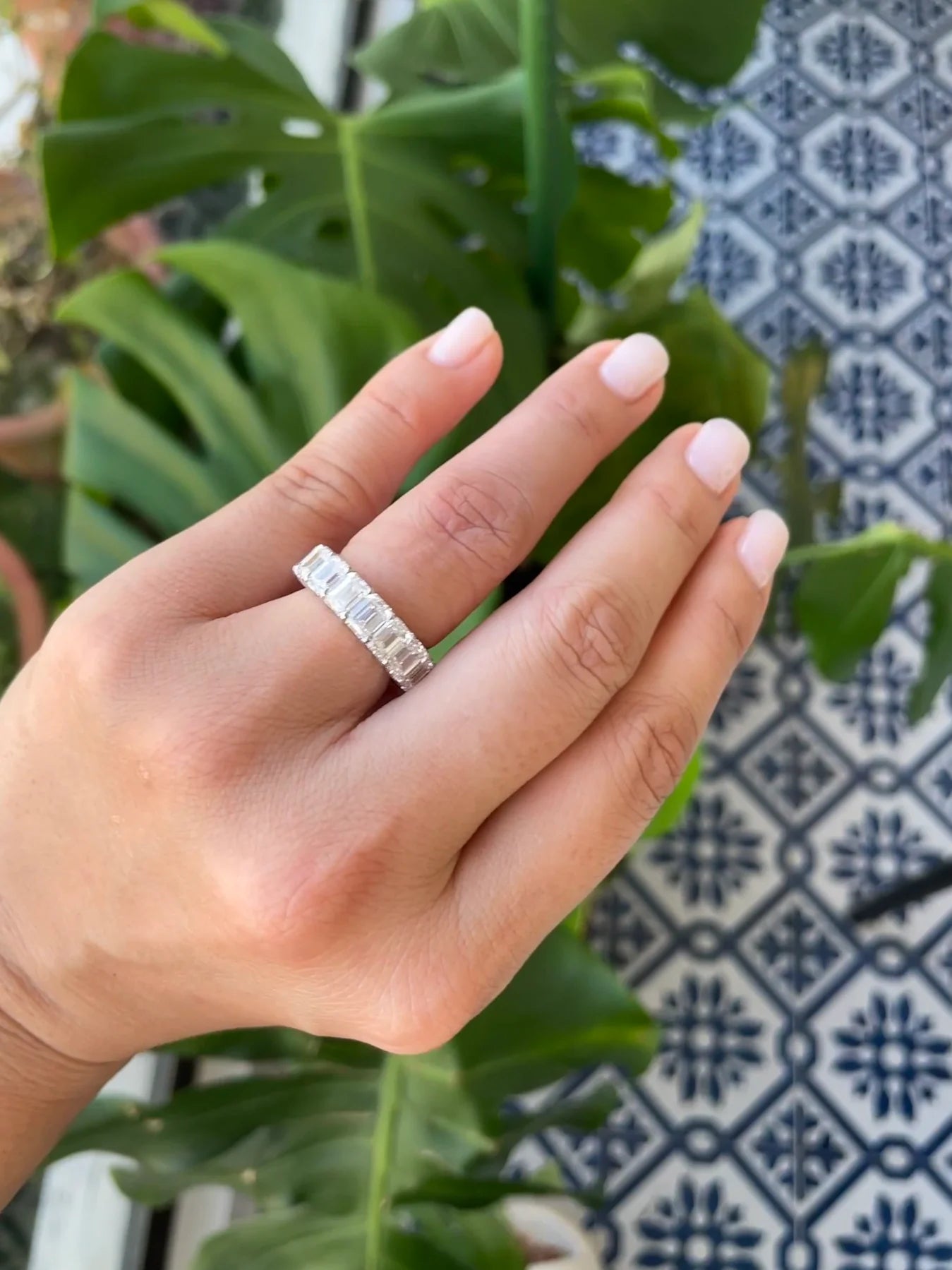 Emerald Cut Diamond Eternity Ring shown on a hand