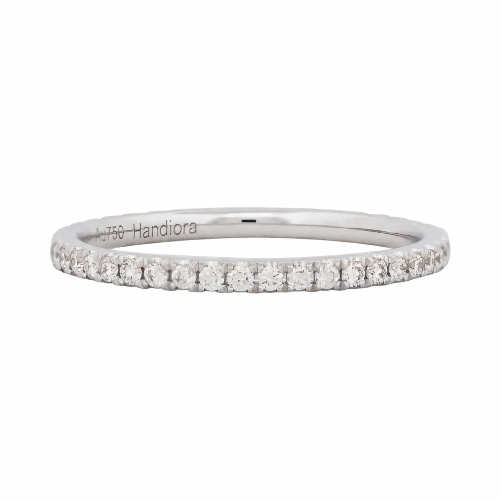 Silver ring with small diamonds on a white background