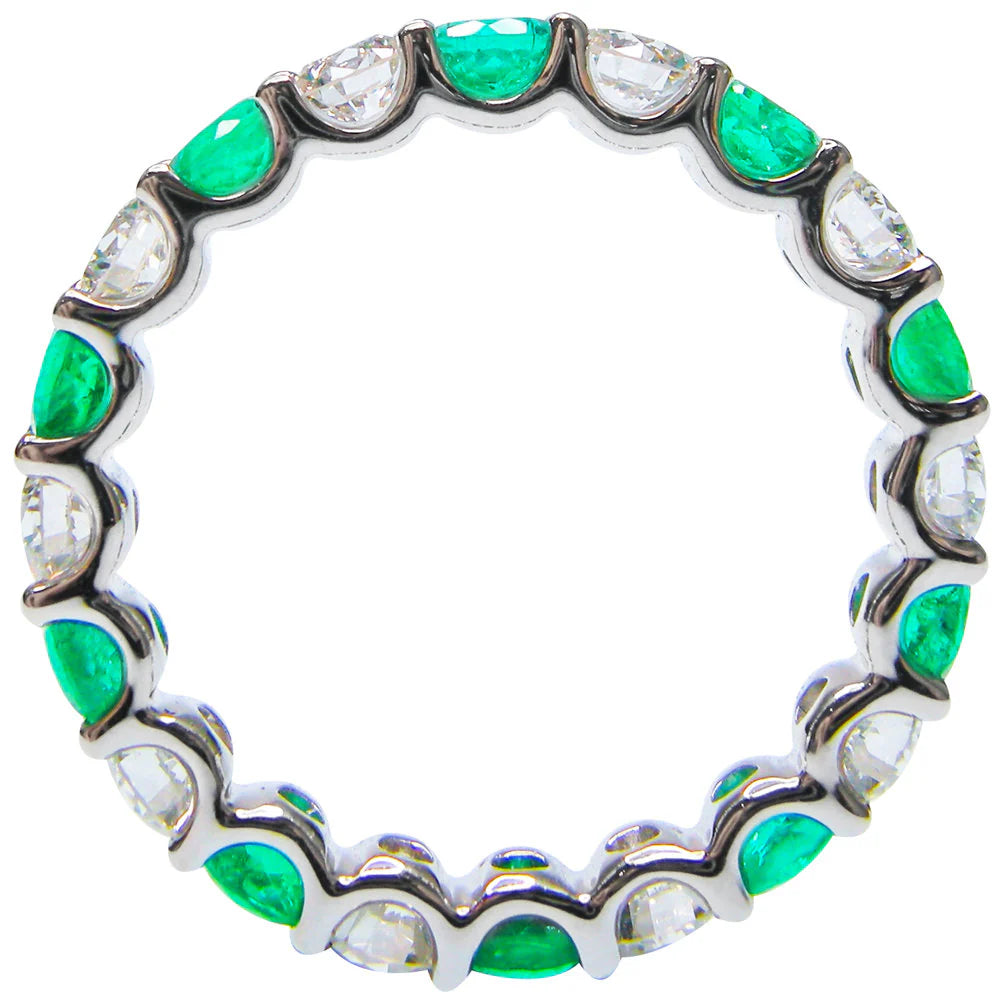 Side view of an alternating emerald and diamond eternity band showing the settings