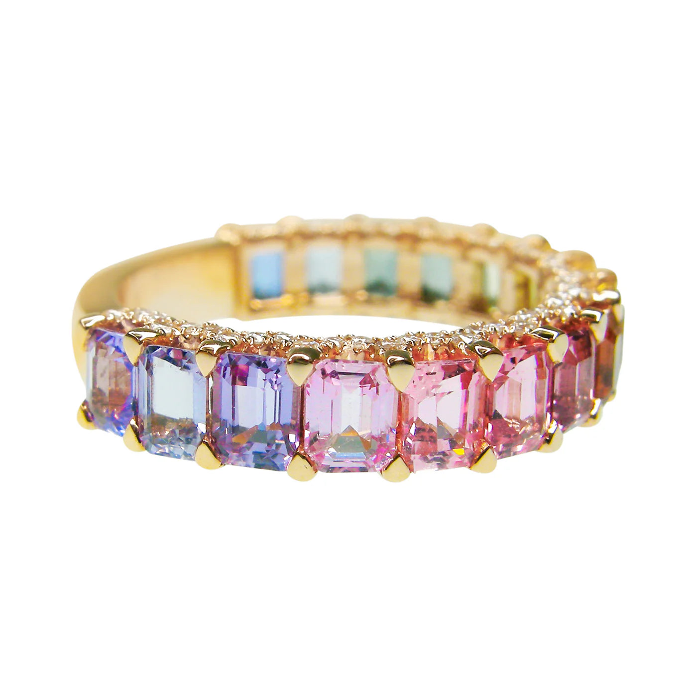 Gold ring with pink and purple gemstones on a white background