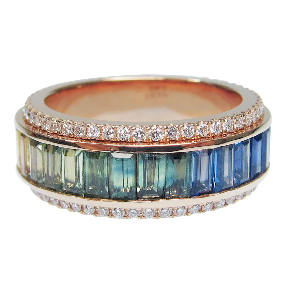 Ring with blue and green gemstones and diamond accents on a white background