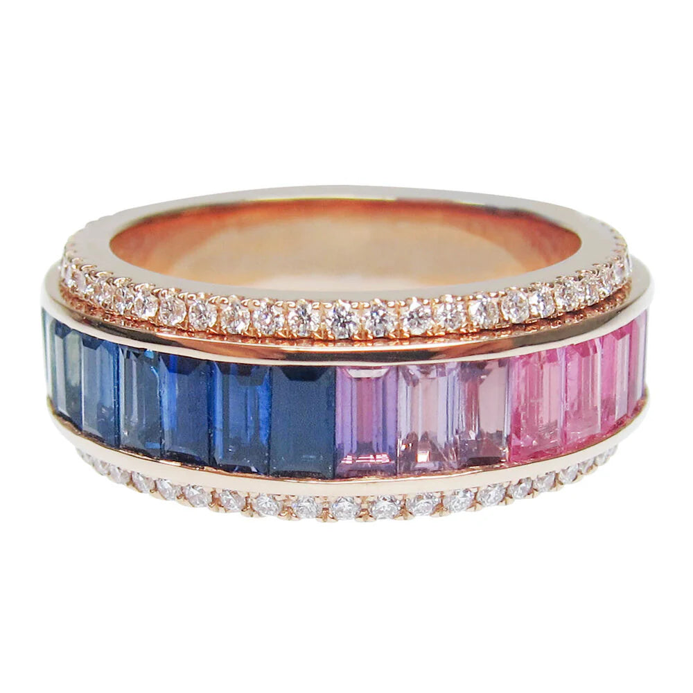 Ring with blue and pink gemstones and diamond-studded band on a white background