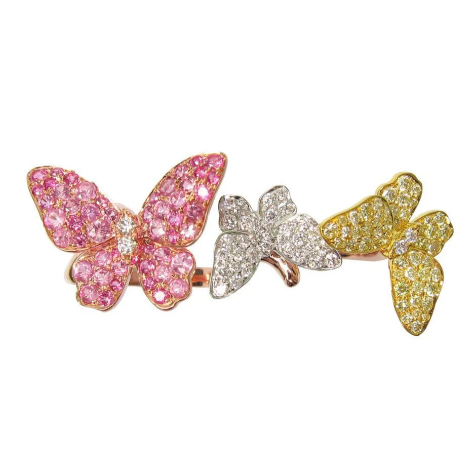 Three butterfly-shaped jewelry pieces in pink, silver, and gold on a white background