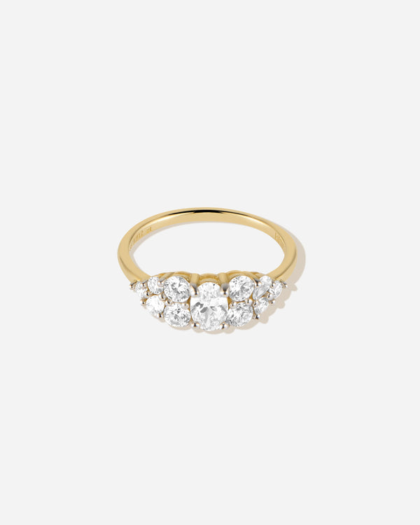 Gold ring with three clear gemstones on a white background