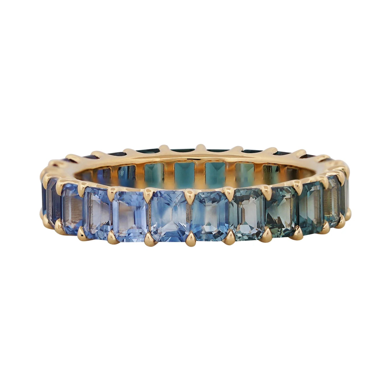 Gold ring with blue gemstones on a white background