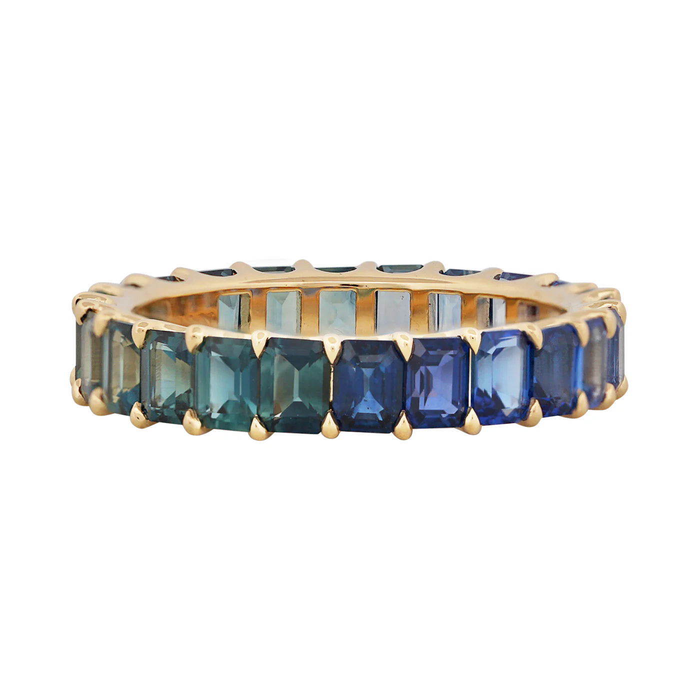 Gold ring with green and blue gemstones on a white background