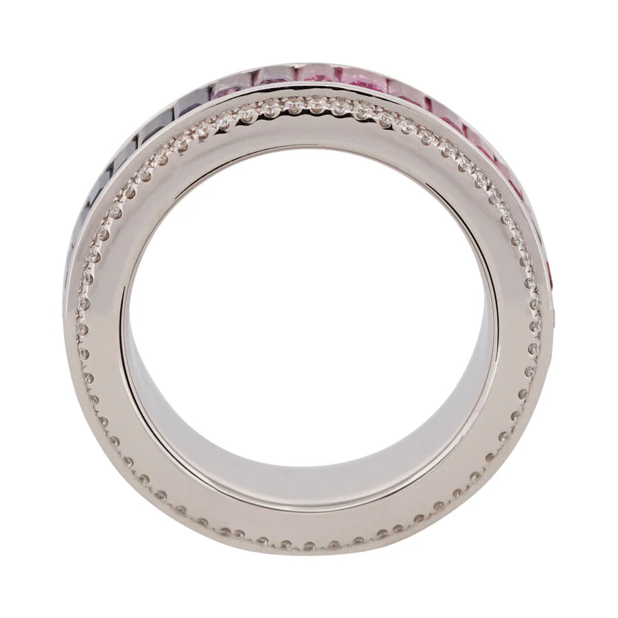 Silver ring with pink gemstones and clear stones on a white background