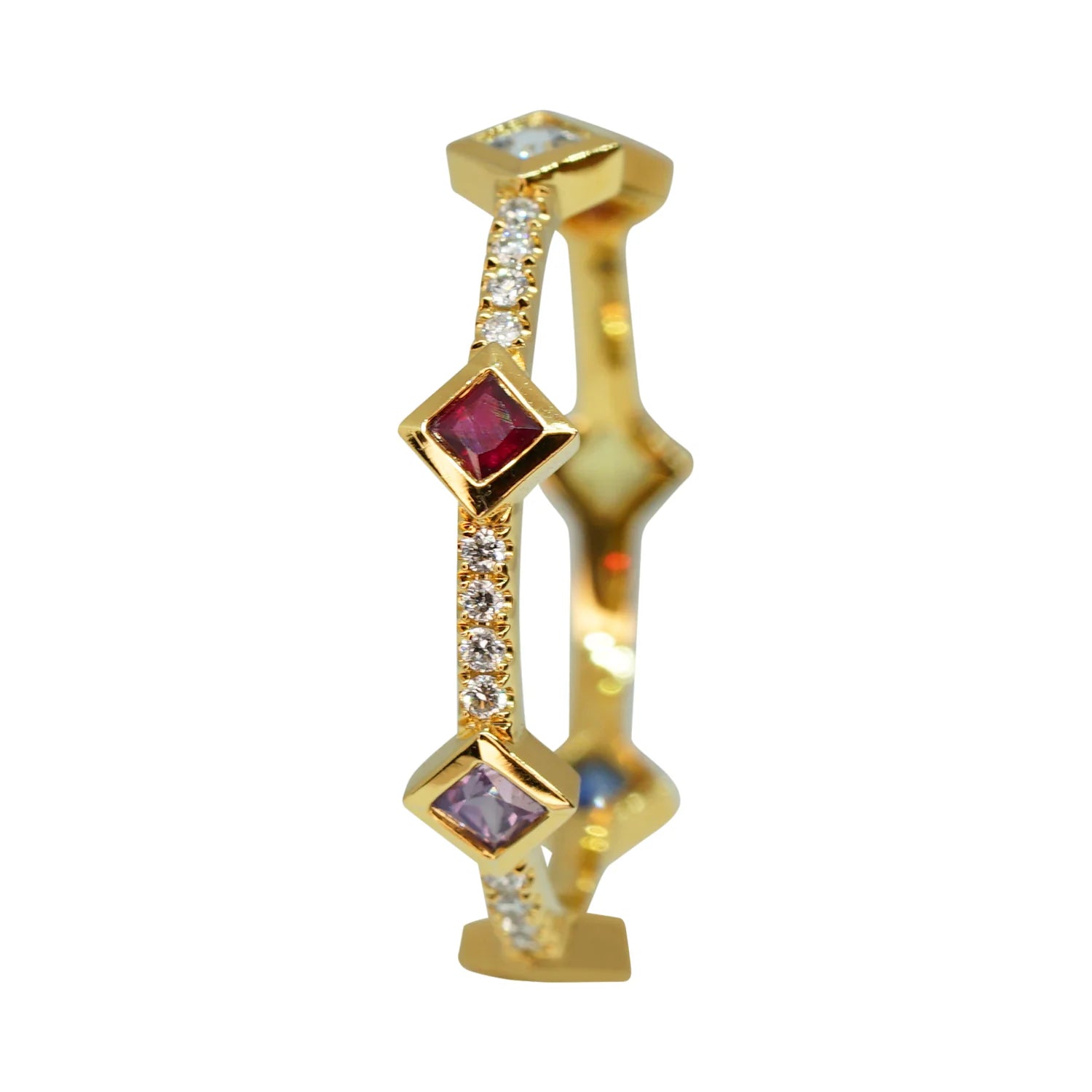 Gold ring with embedded gemstones on a white background
