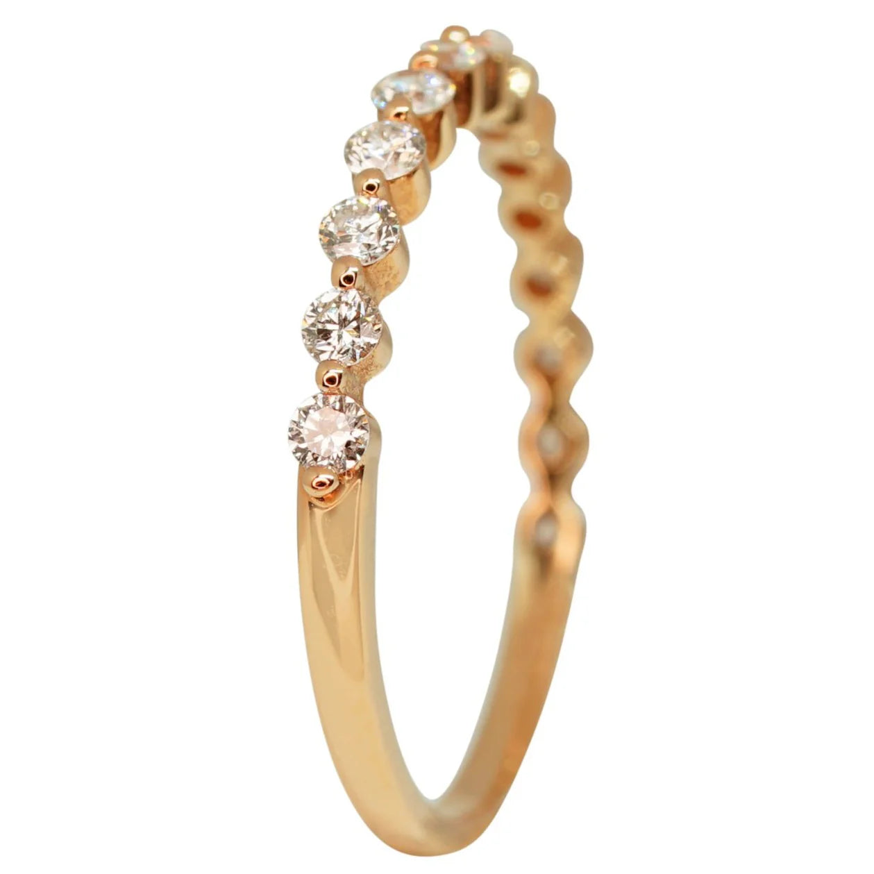 Gold ring with small diamonds on a white background