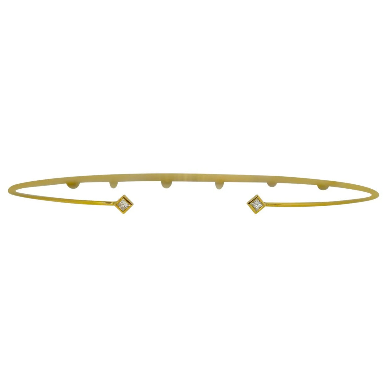 Gold bangle with diamond accents on a white background