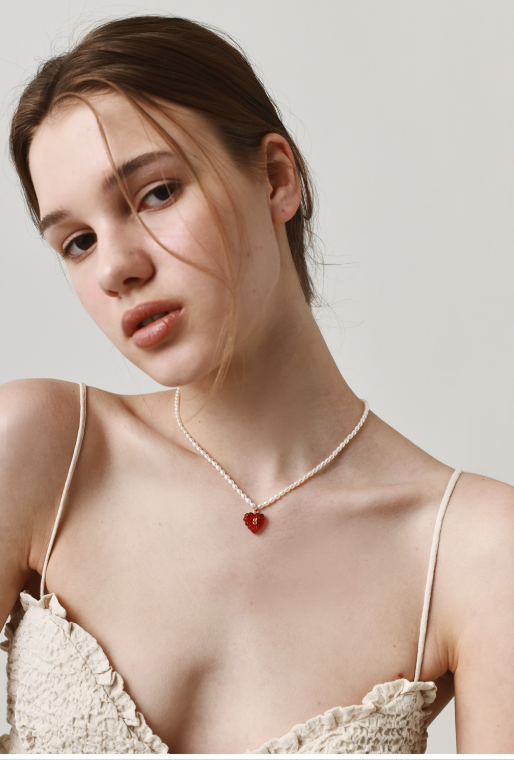 Detailed view of resin and brass heart pendant design