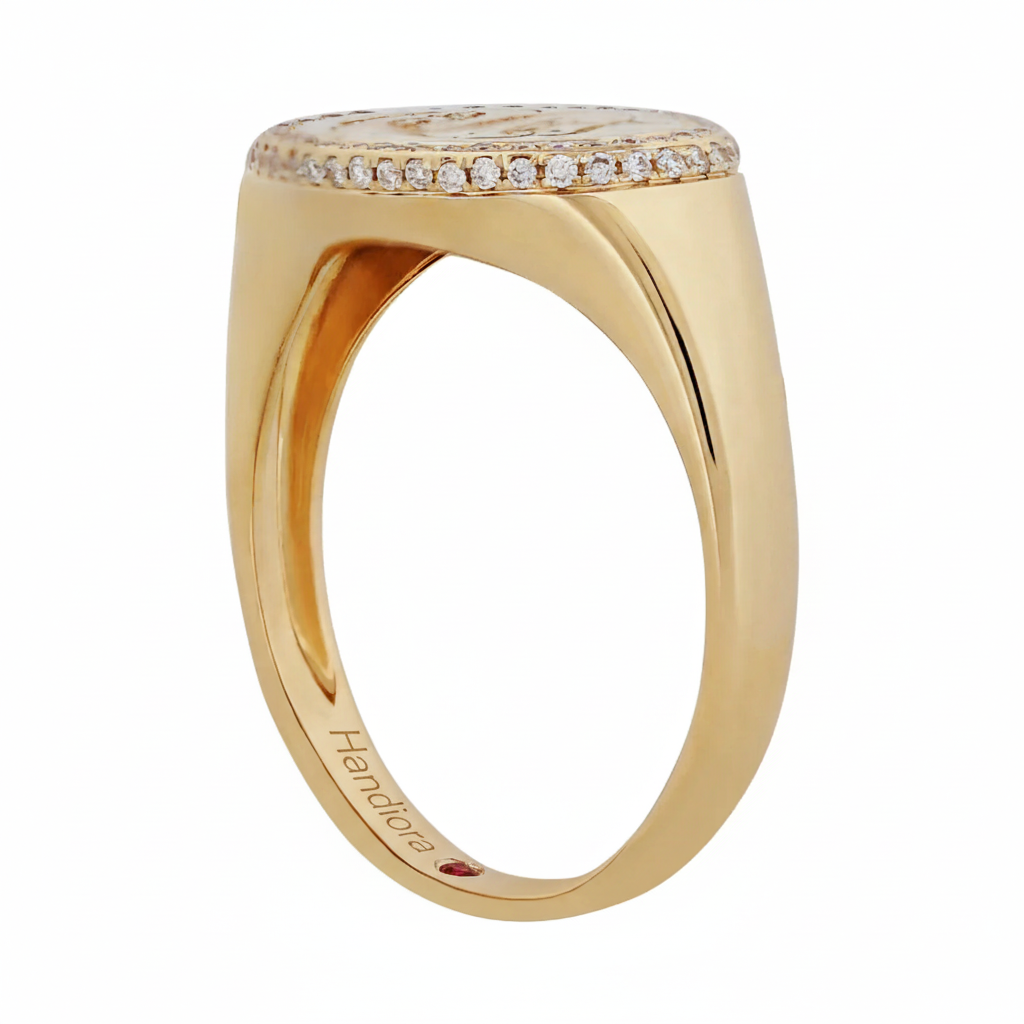 Gold ring with diamond accents on a white background