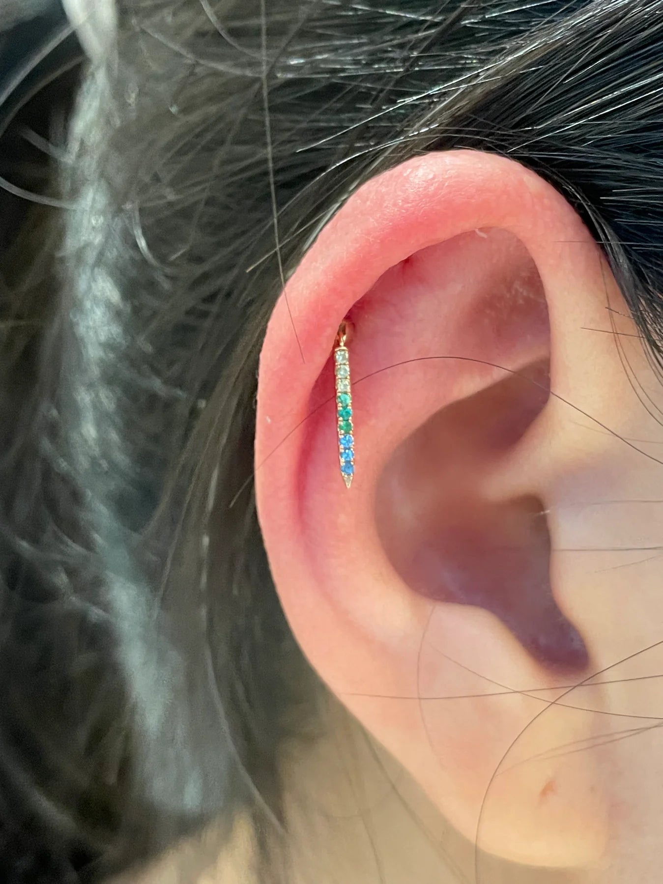 Close-up of an ear with a diamond earring