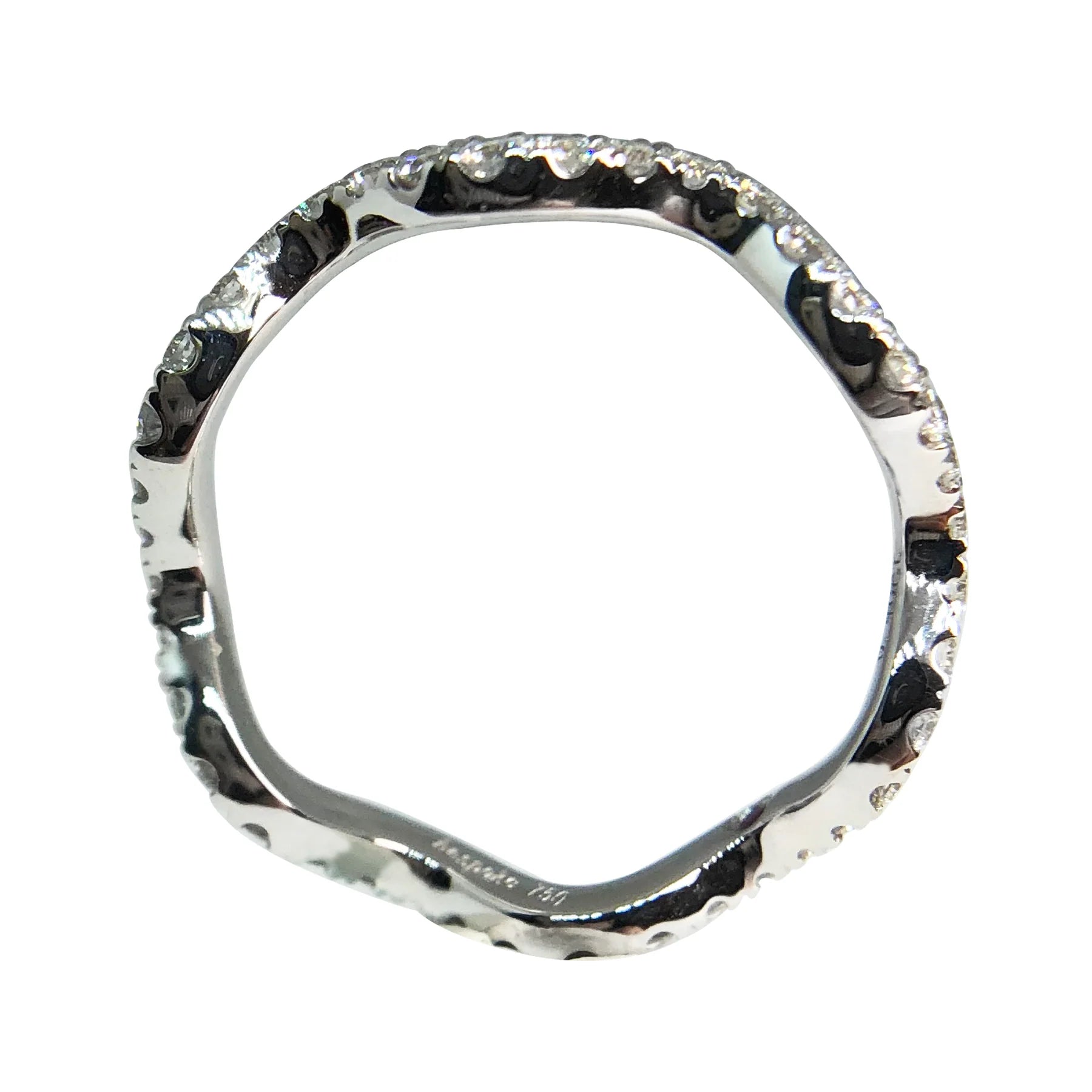 Silver ring with a textured band on a white background