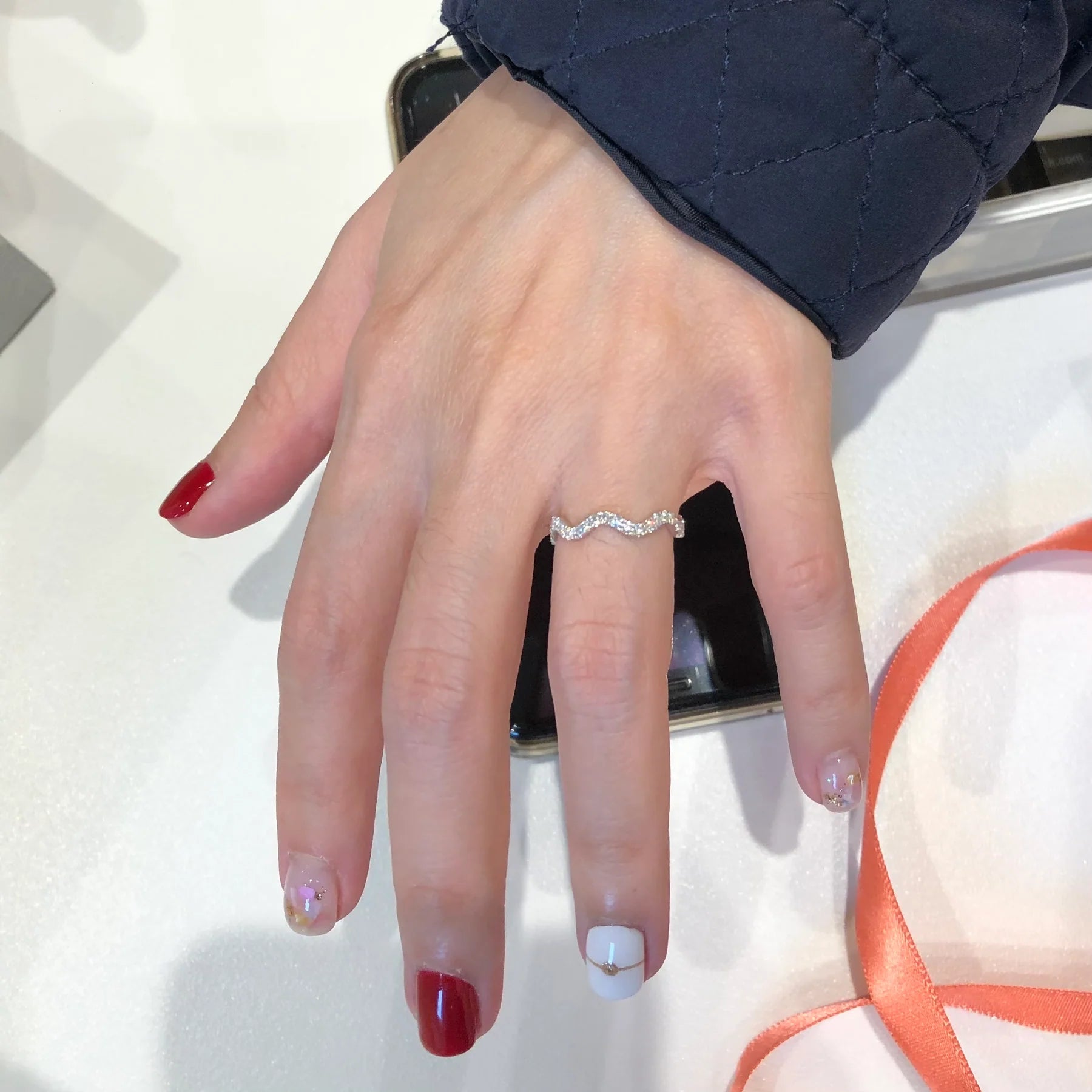 Hand wearing a ring with a white background