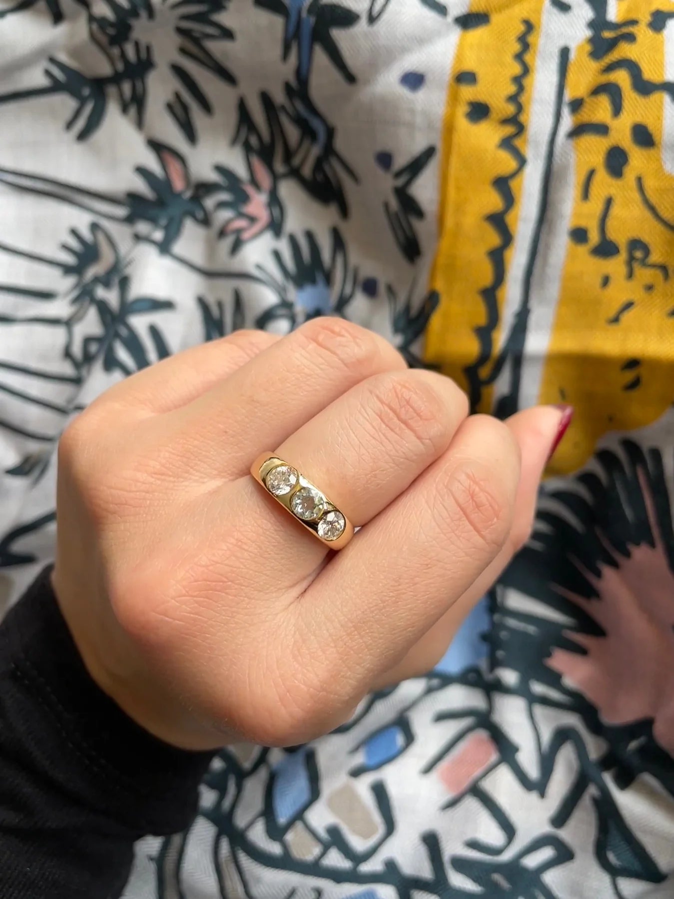 Close-up shot of the three brilliant round diamonds on the ring