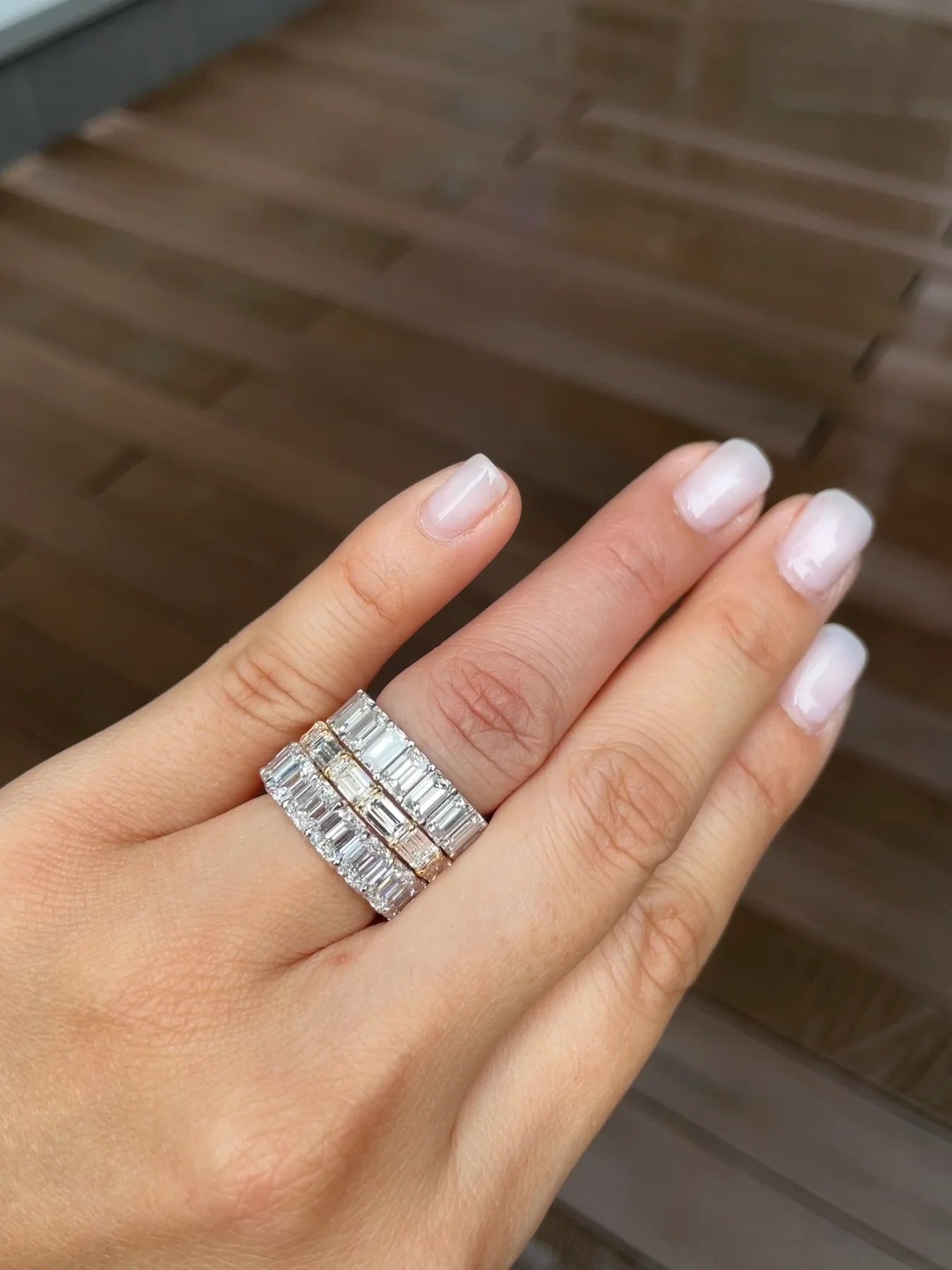 Emerald Cut Diamond Eternity Ring shown on a hand