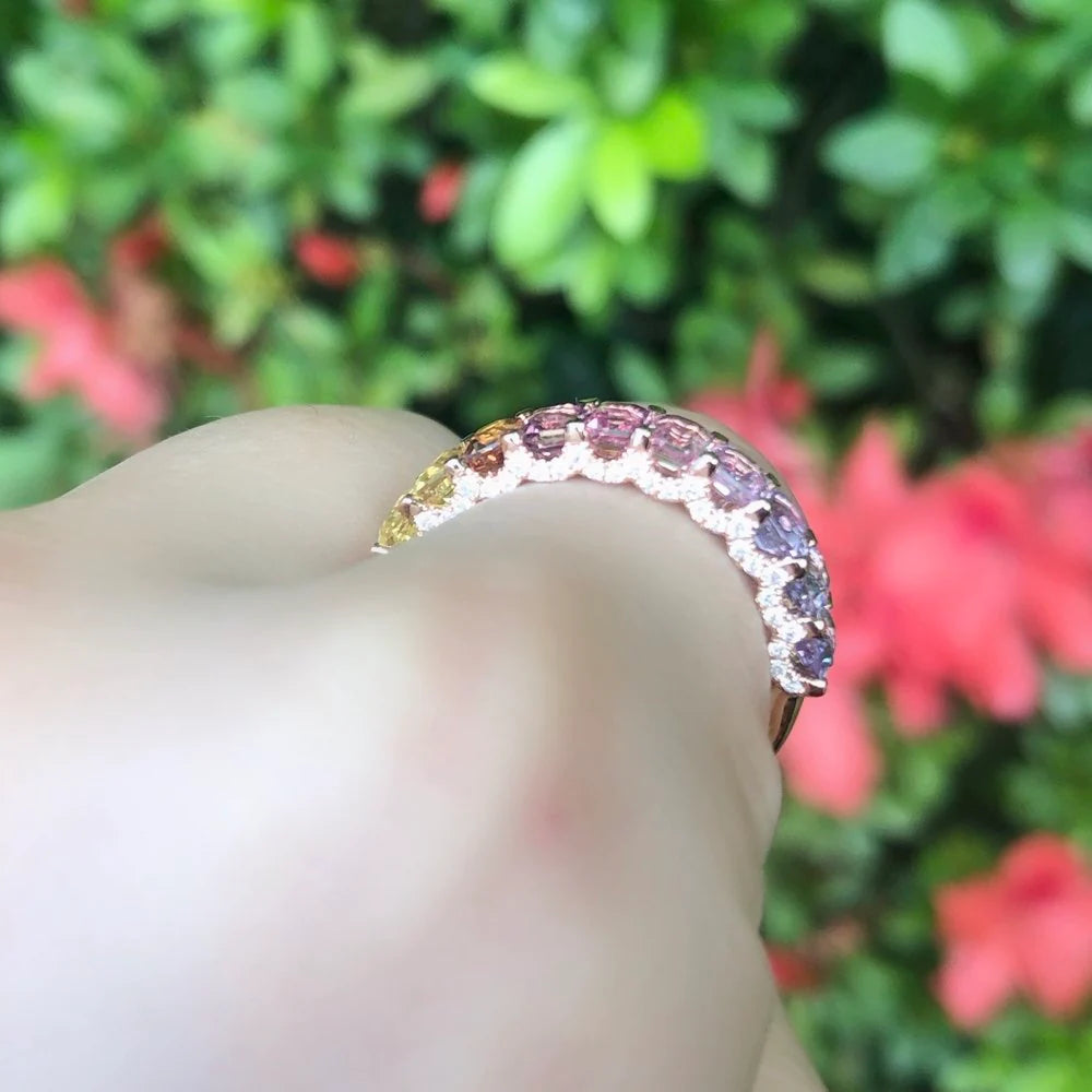 Ring with a colorful gemstone on a blurred floral background