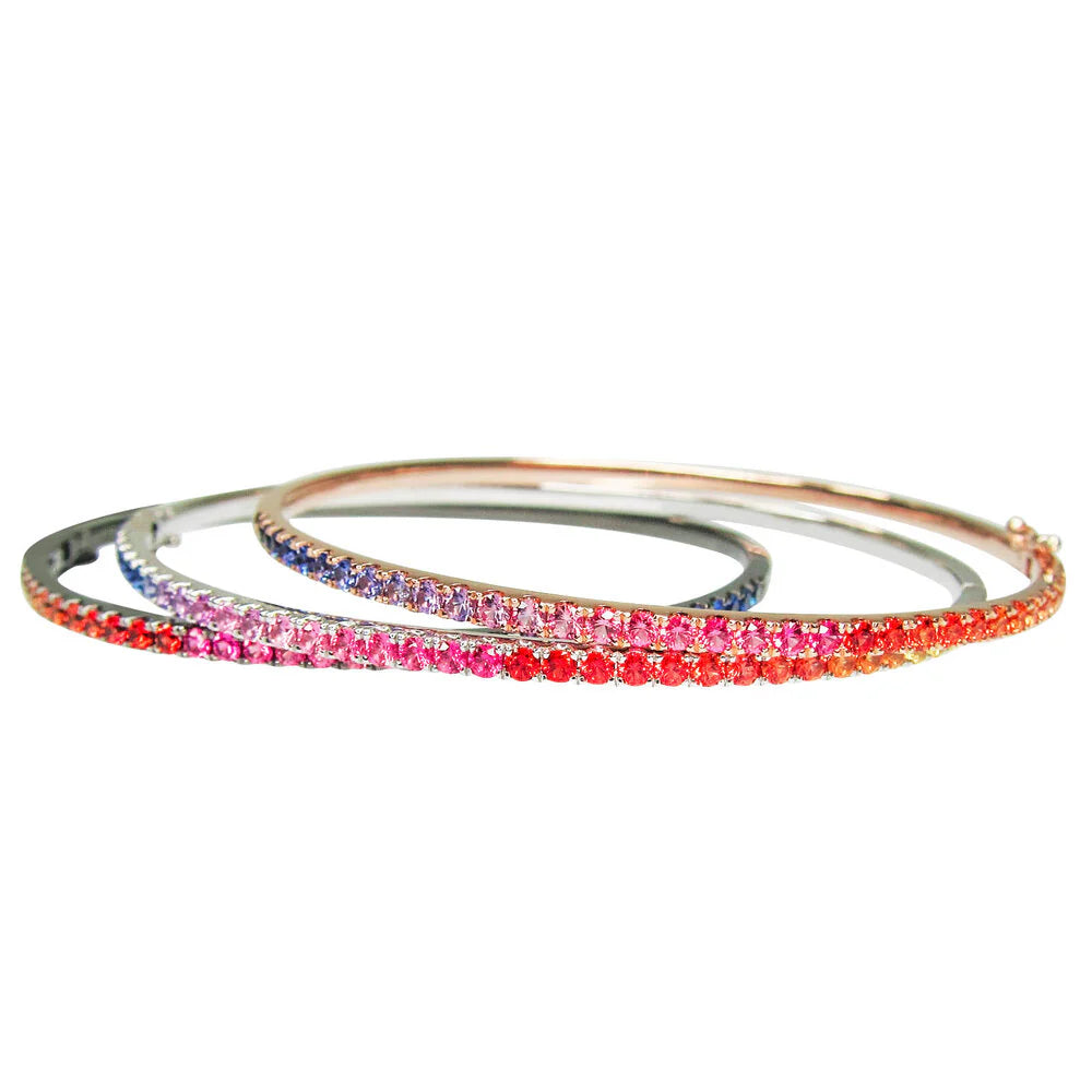 Set of three bangles with colorful stones on a white background