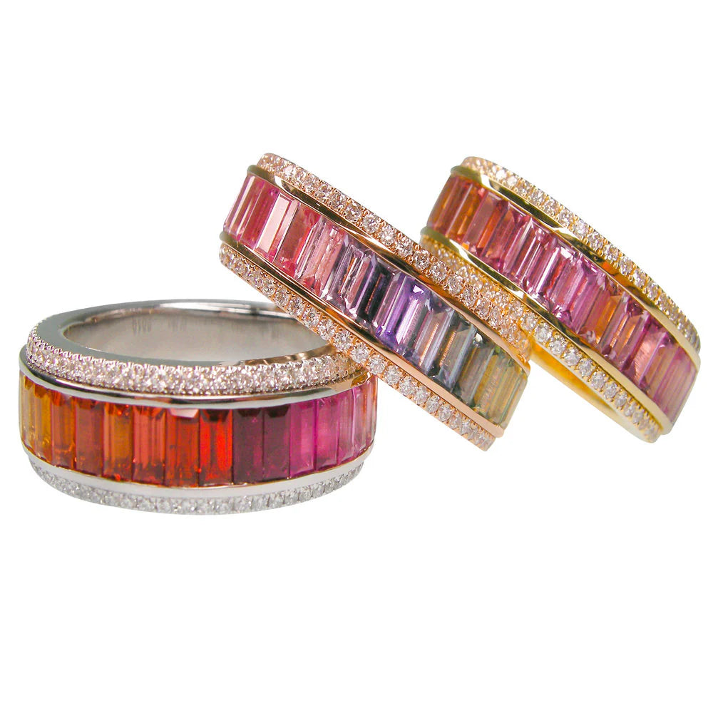 Three colorful gemstone rings with gold, silver, and rose gold bands on a white background.