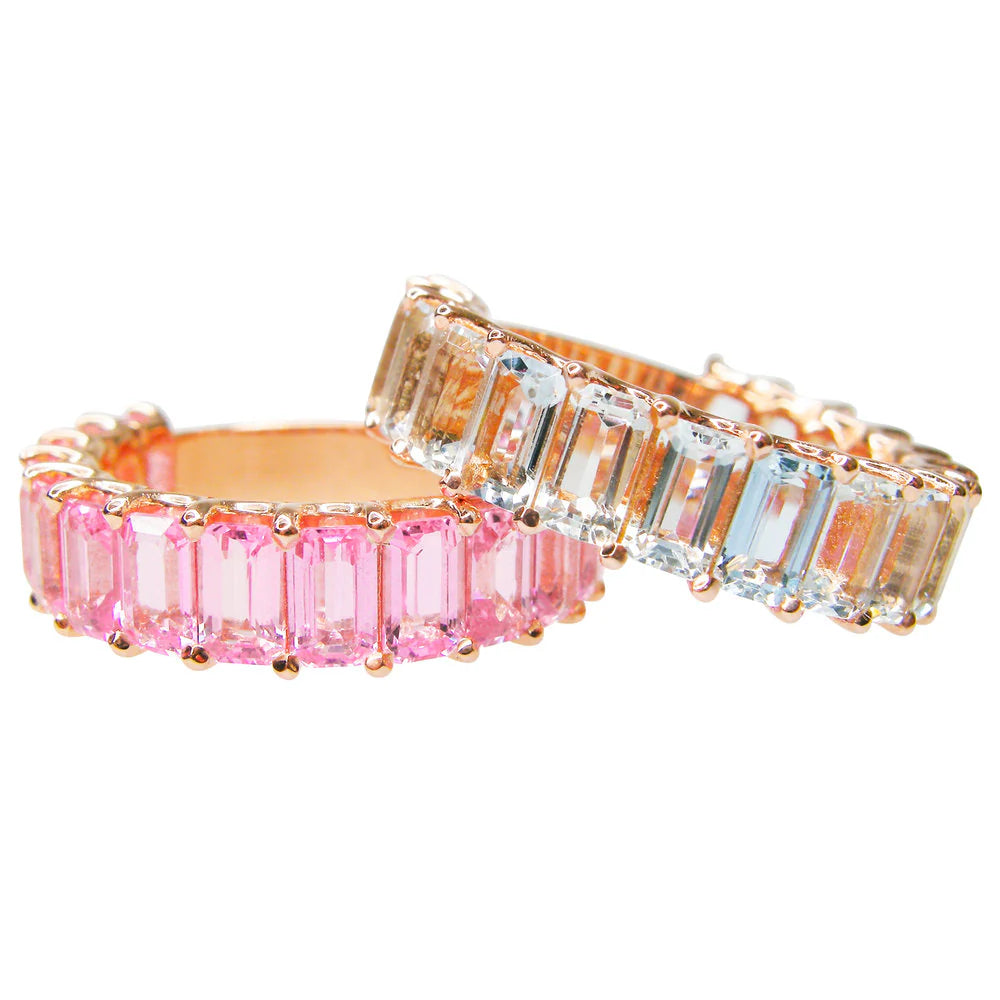 Two rings with pink and clear gemstones on a white background